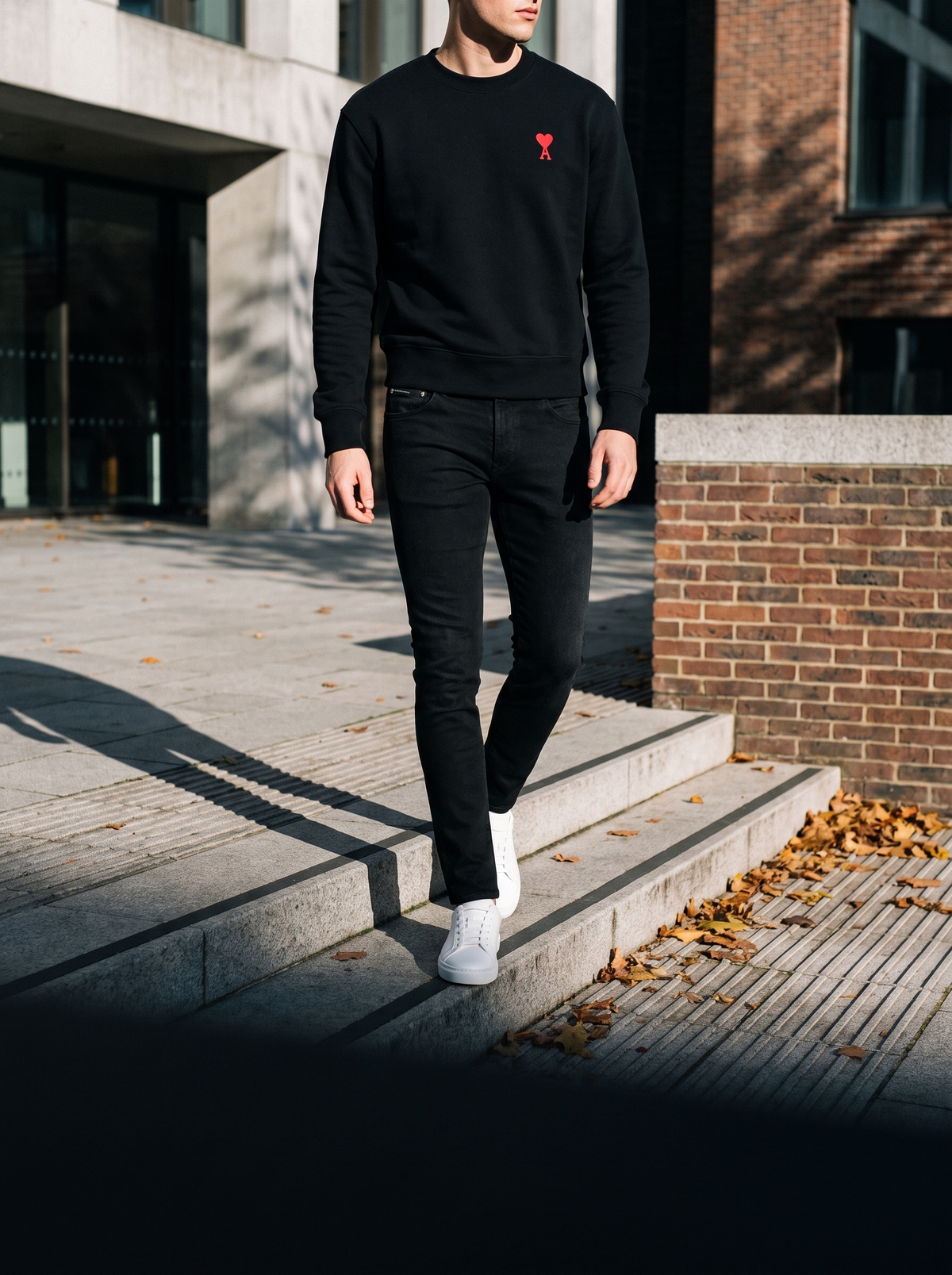 Model wearing Dolce & Gabbana logo jeans and an Ami Paris crewneck