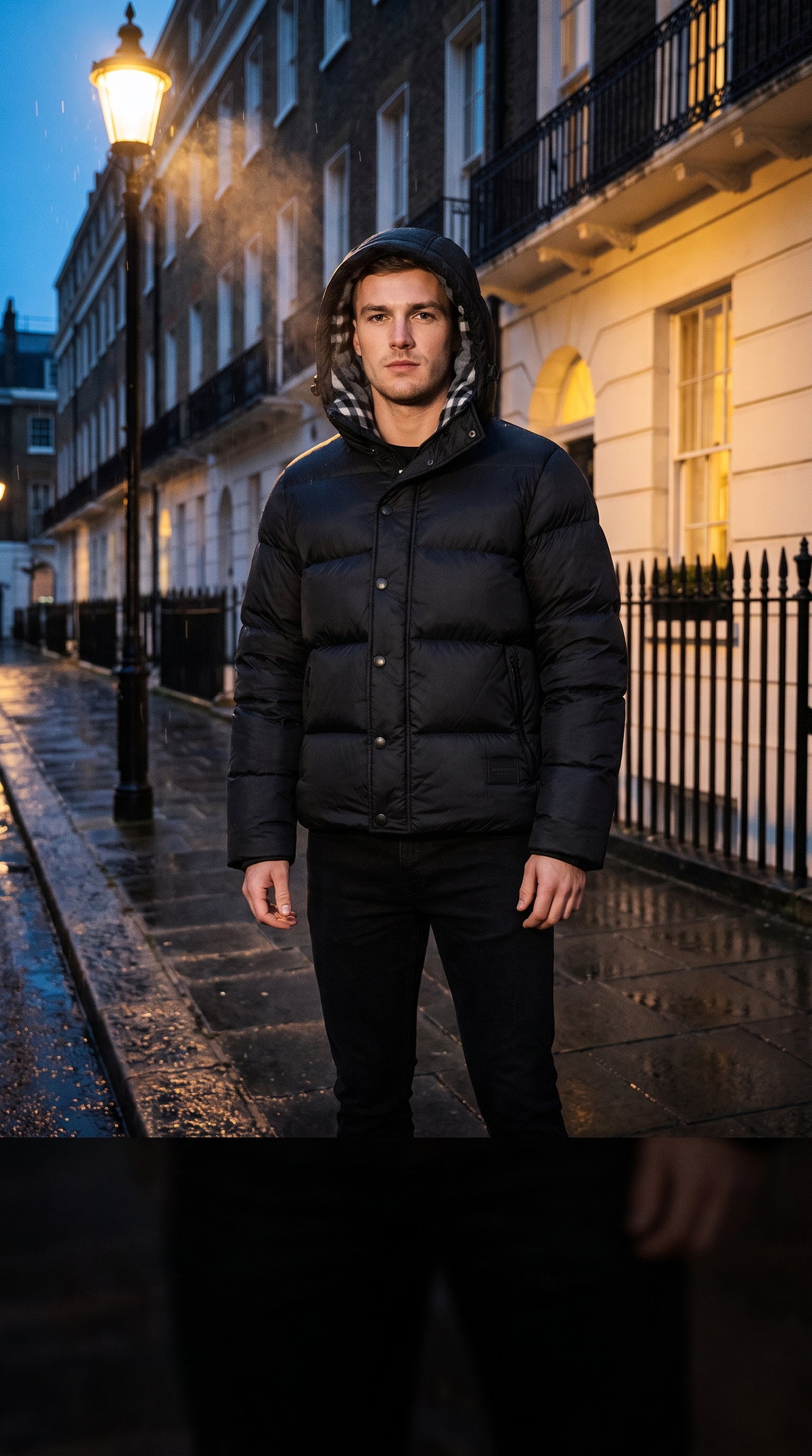 Model wearing the Burberry Halsby puffer jacket, hood up, on a London street at night